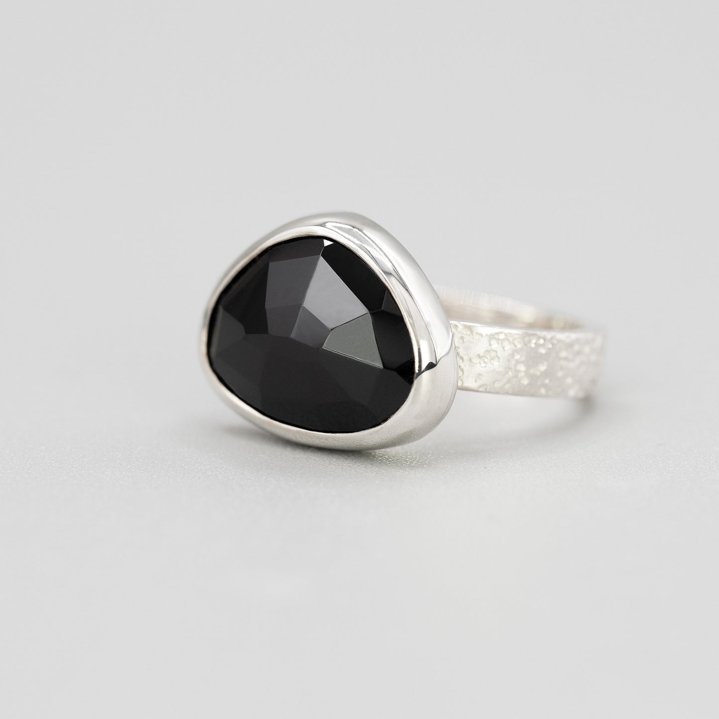 Silver ring with black spinel gemstone in a bezel setting