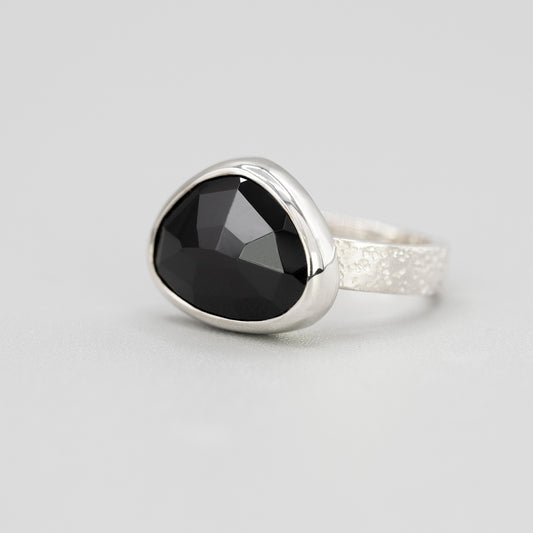 Silver ring with black spinel gemstone in a bezel setting 